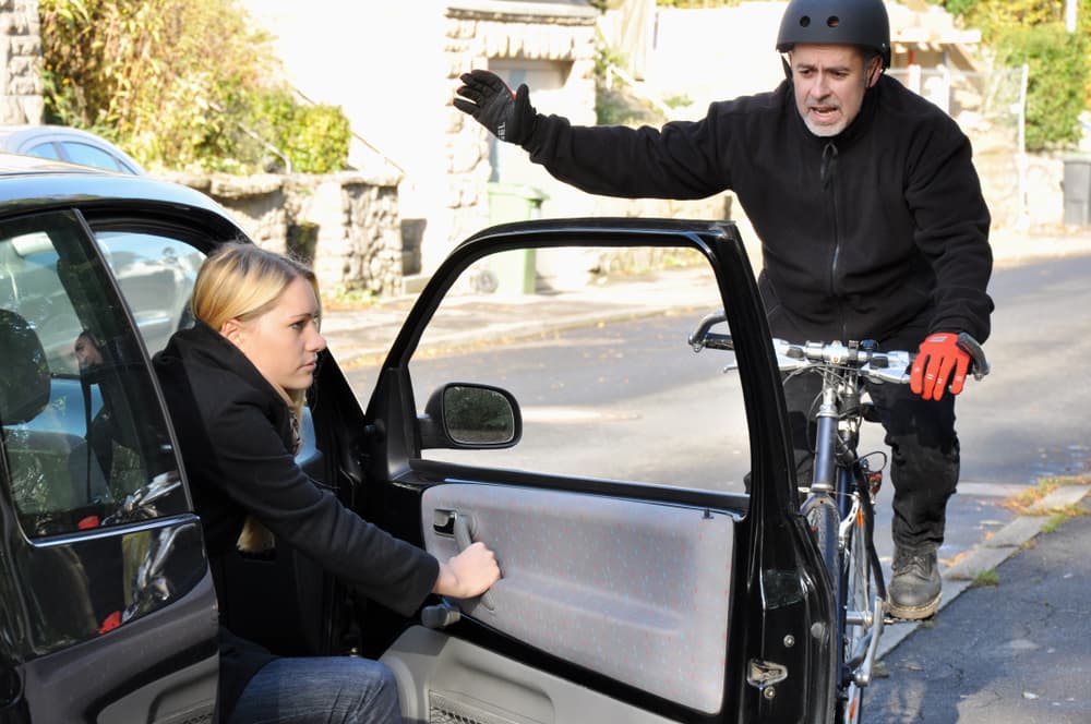 Risk to cyclists as car door opens onto bike path