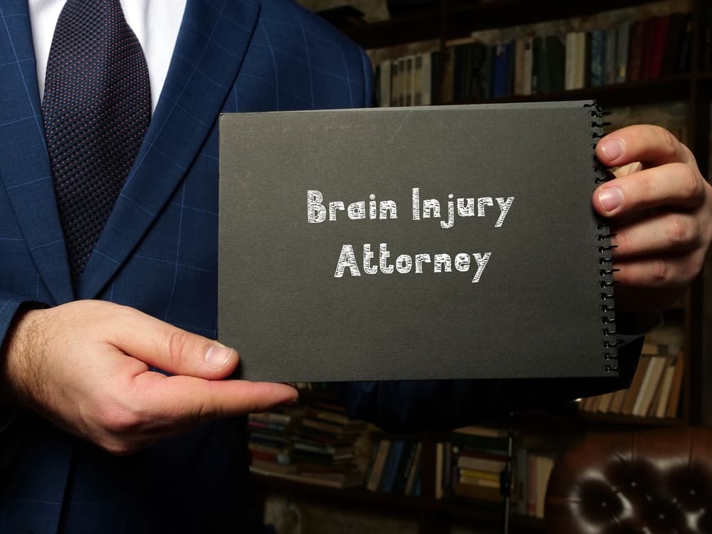 Inscription on a document: 'Brain Injury Attorney,' emphasizing legal expertise in cases related to brain injuries.