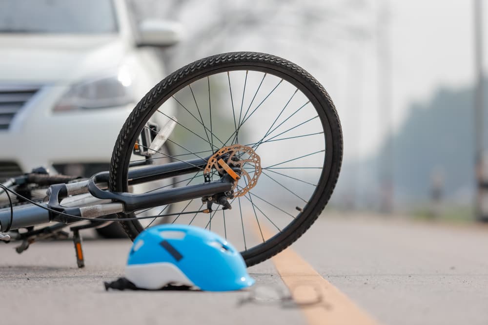 Crashed bicycle on the road after hit by car.