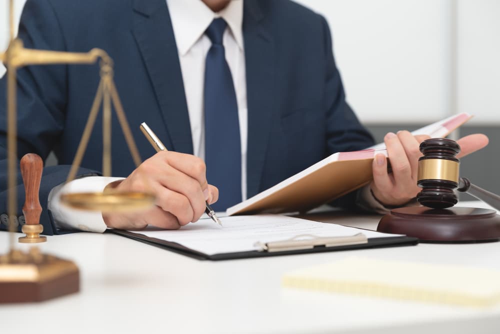 An attorney reviewing legal documents in the office, representing law and justice.