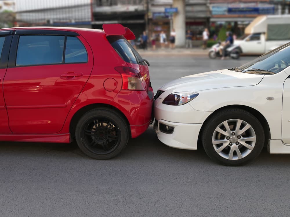 The aftermath of a car crash, highlighting vehicle damage for an insurance claim.