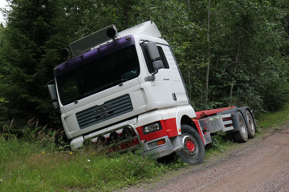 A damaged truck in the ditch.