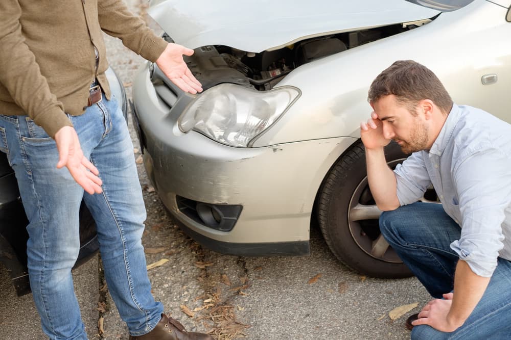 In Chicago, Illinois, two men involved in a car accident arguing on the road.