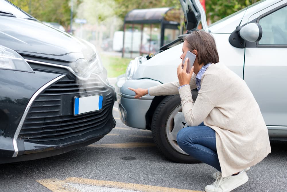 Female on phone seeking assistance after car accident in Chicago, IL