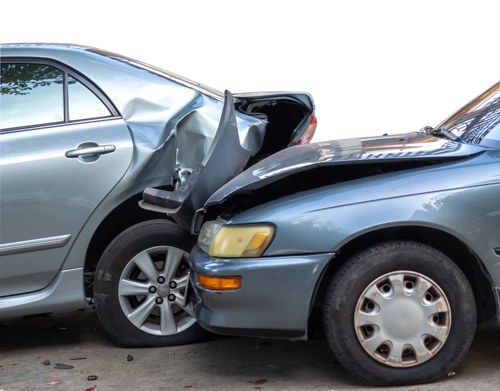 Automobile collision scene showing wrecked cars on the street resulting from negligent driving.