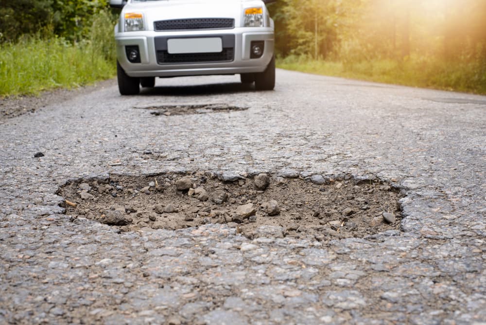 Deep pothole causes auto accident