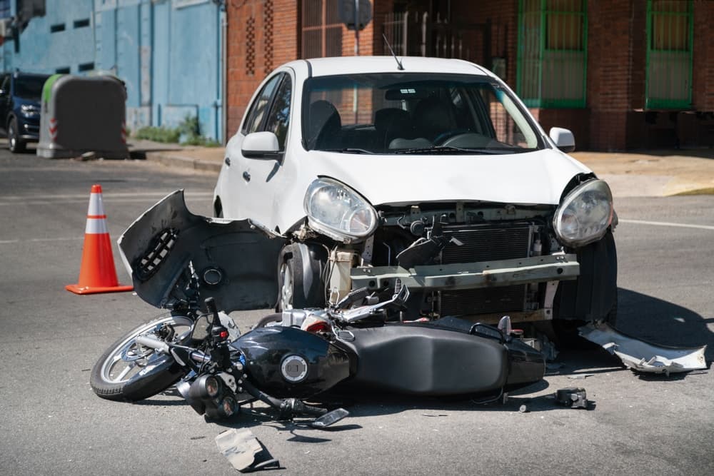 Motorcycle struck by car in a traffic collision.