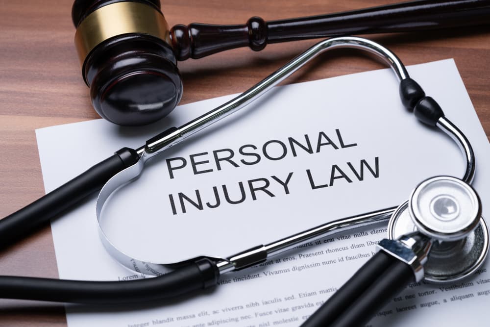 Elevated View of a Gavel and Stethoscope on a Personal Injury Law Document.