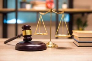Justice scales and a wooden gavel symbolizing law, fairness, and justice.