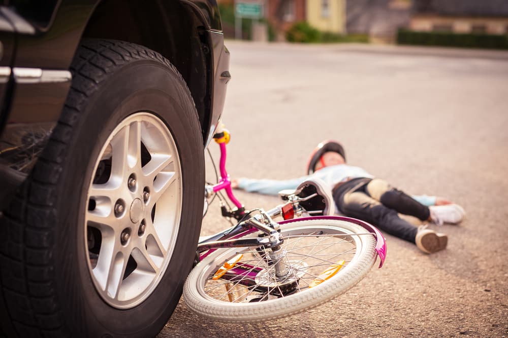 Child injured in accident after being hit by a car while riding a bicycle.