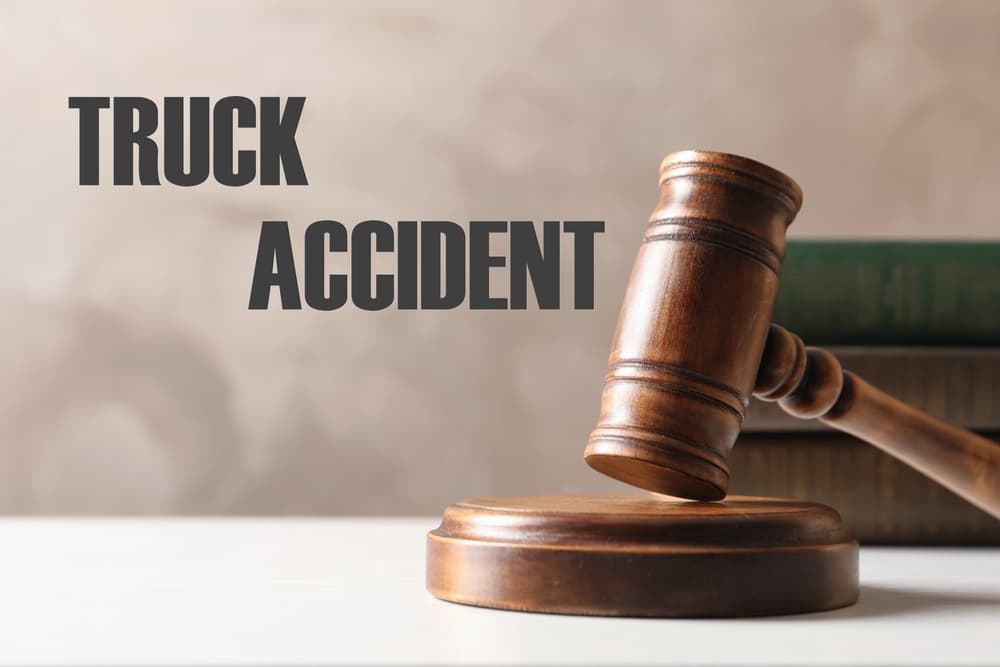 Truck accident law, represented by a wooden judge's gavel and law books placed on a table, signifying legal proceedings and expertise in handling truck-related accidents.