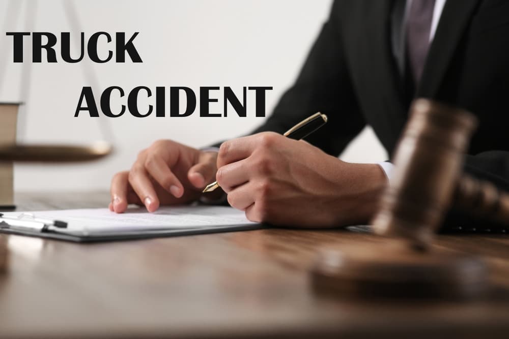 Truck accident law concept. Close-up of a judge working at a wooden table with legal documents and gavel.